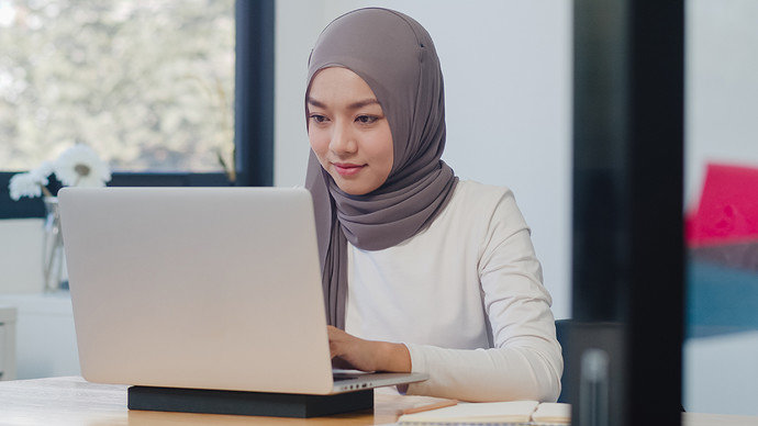 beautiful-asian-muslim-lady-casual-wear-working-using-laptop-modern-new-normal-office