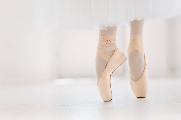 young-ballerina-closeup-legs-shoes-standing-pointe-position_155003-9443
