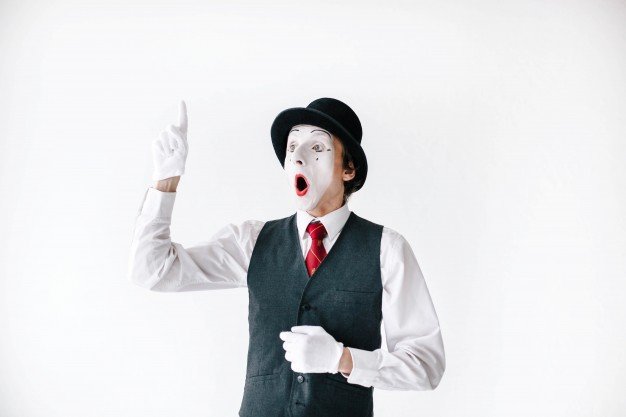 surprised-mime-holds-his-finger-up_1304-2791